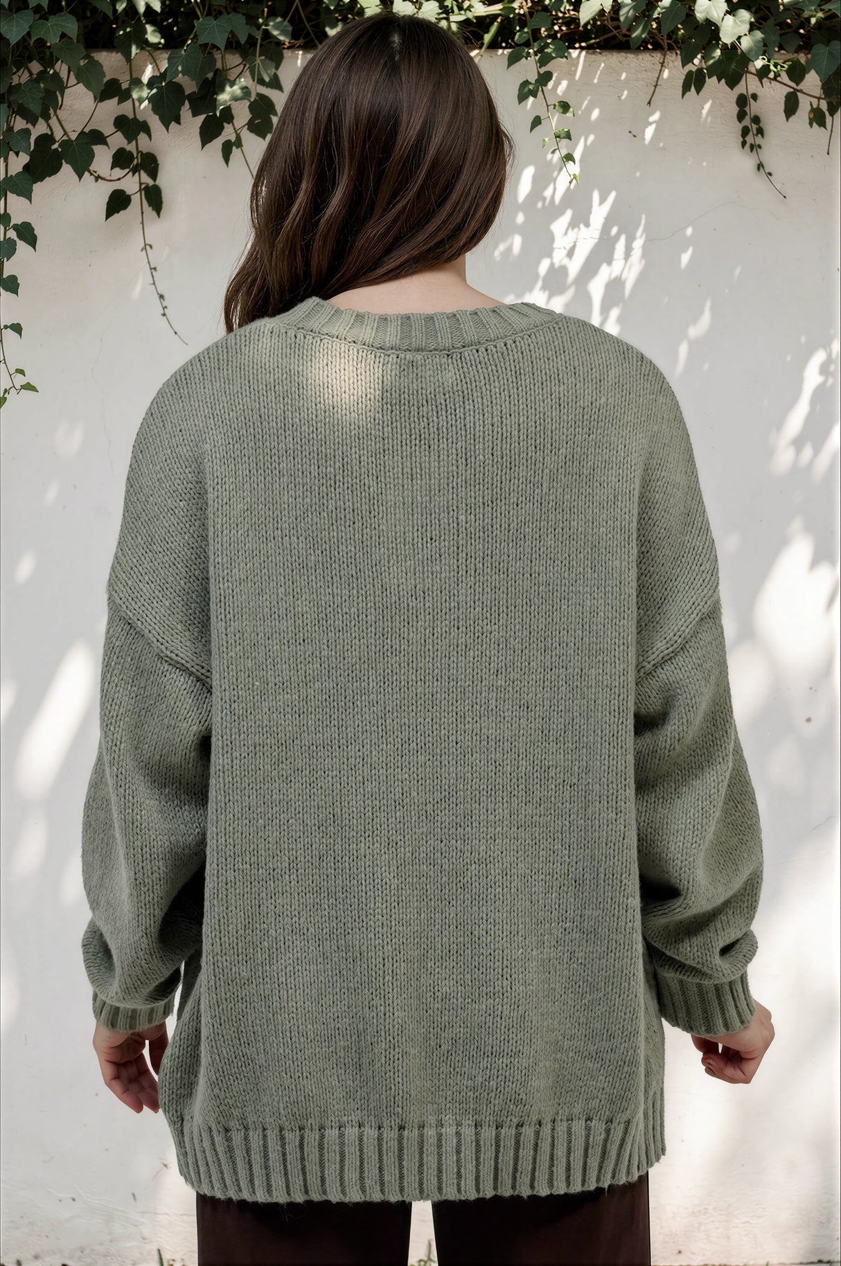 Model wearing Caesar Jumper in Green from Salty Crush