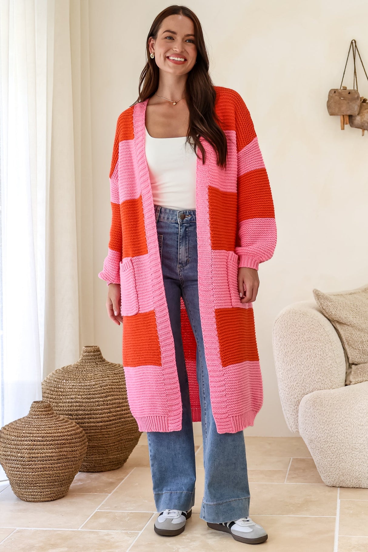Model wearing Finneas Cardigan in Pink from Salty Crush