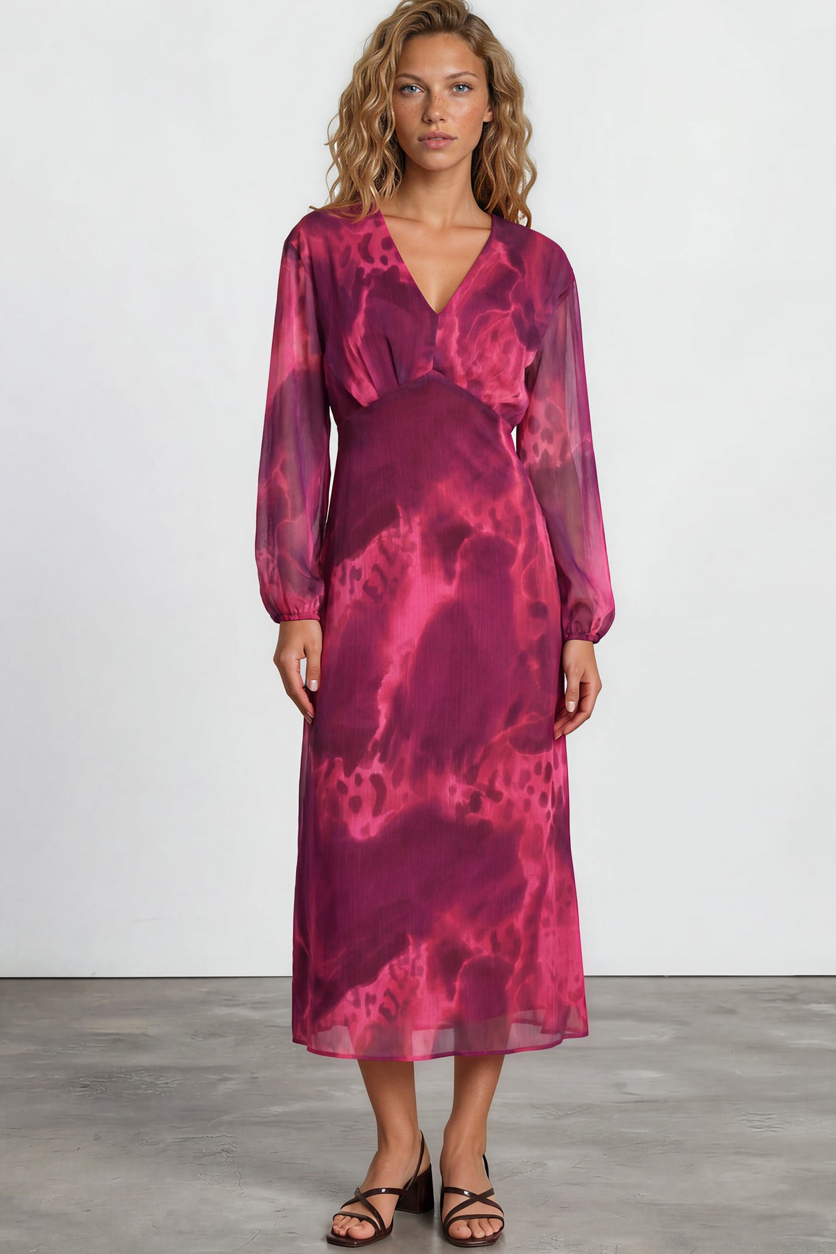 Woman wearing a pink tie-dye dress on a white background