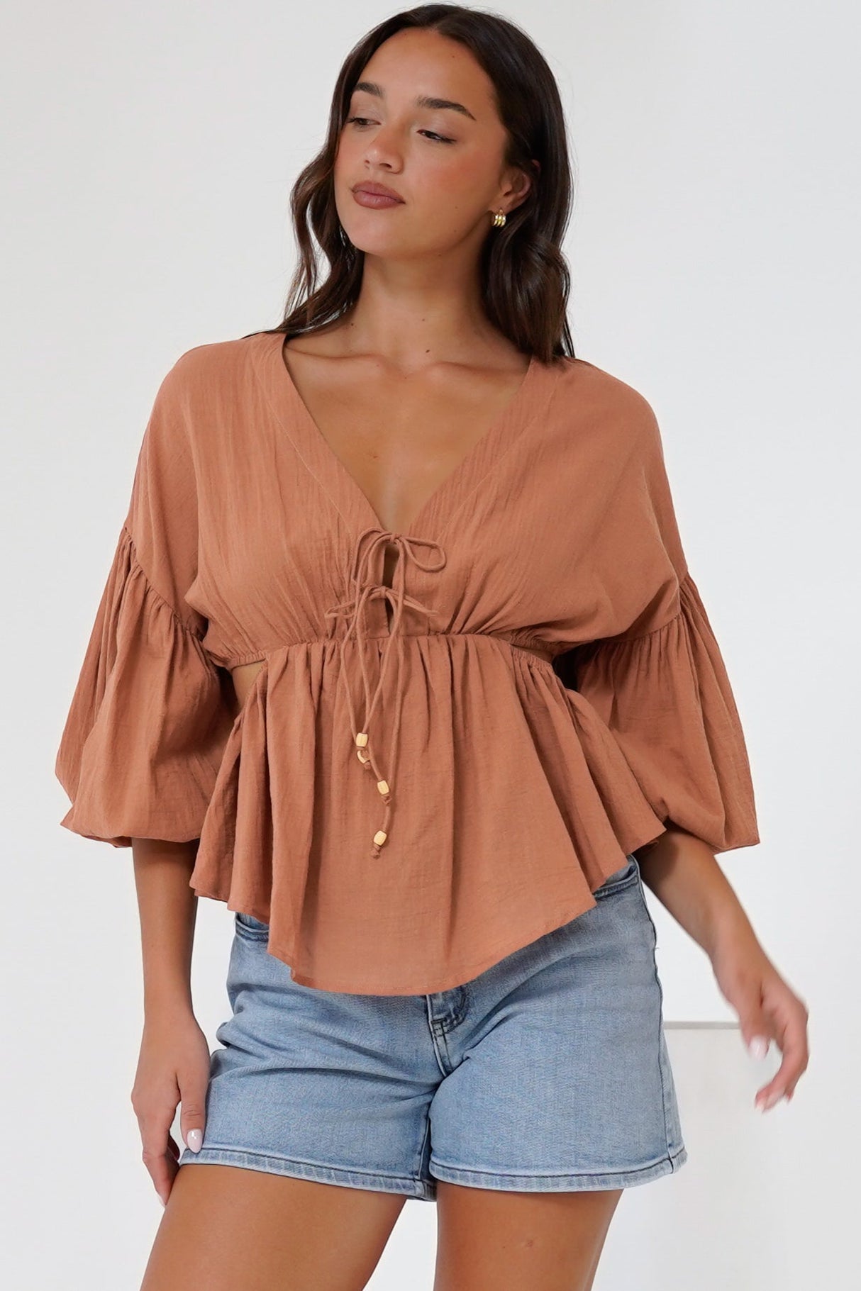 Jacobson Top - Peplum Top with Side Cut Outs and Voluminous Sleeves in Tan