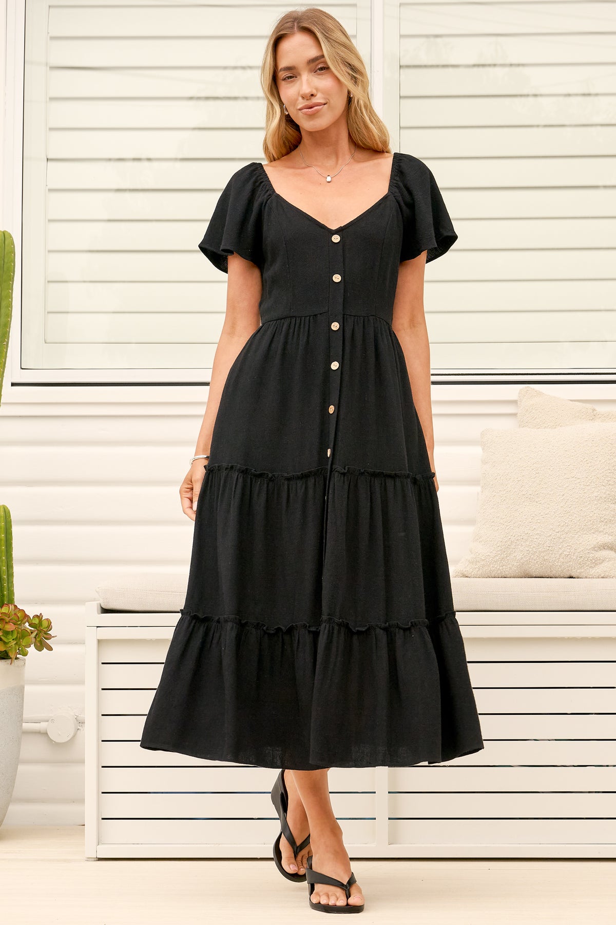 Model wearing Karina Midi Dress in Black from Salty Crush