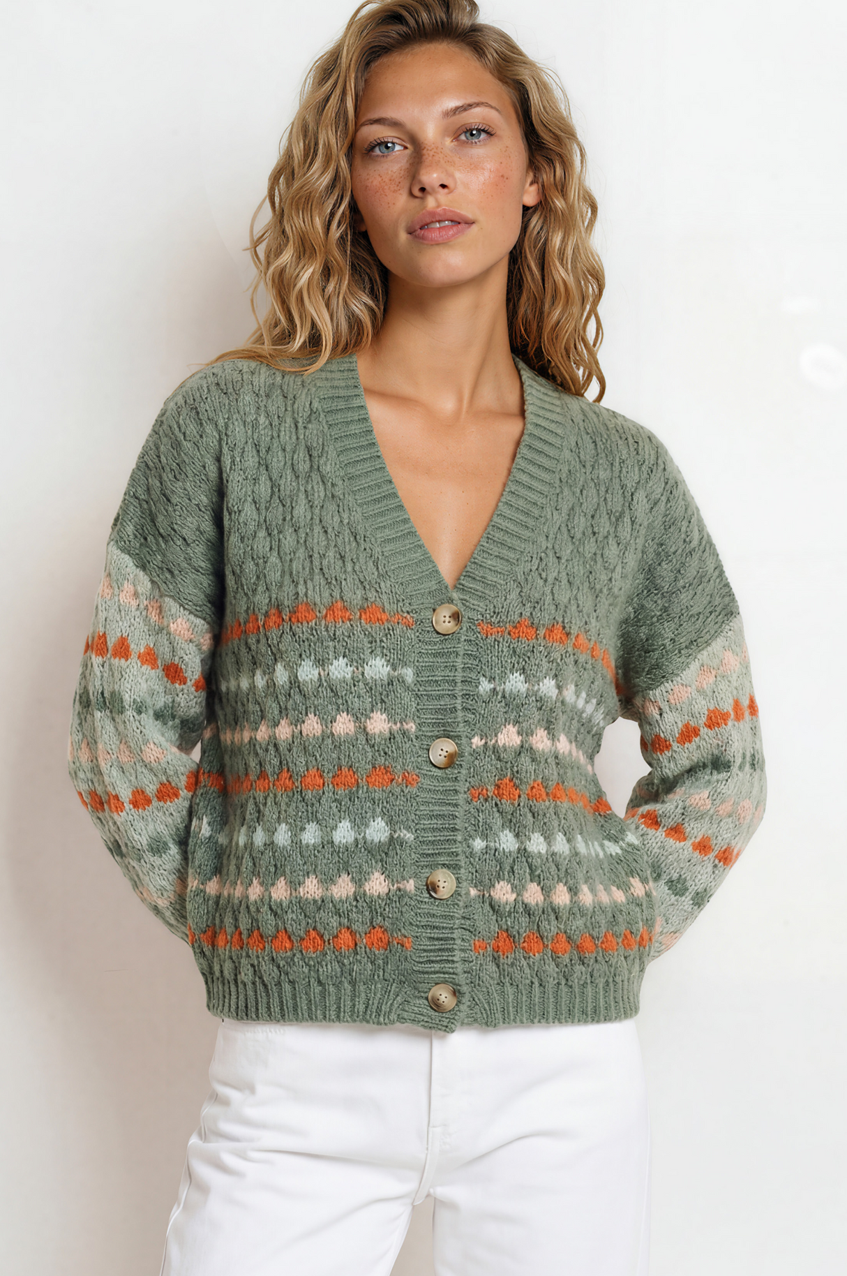 Woman wearing a green patterned sweater against a white background