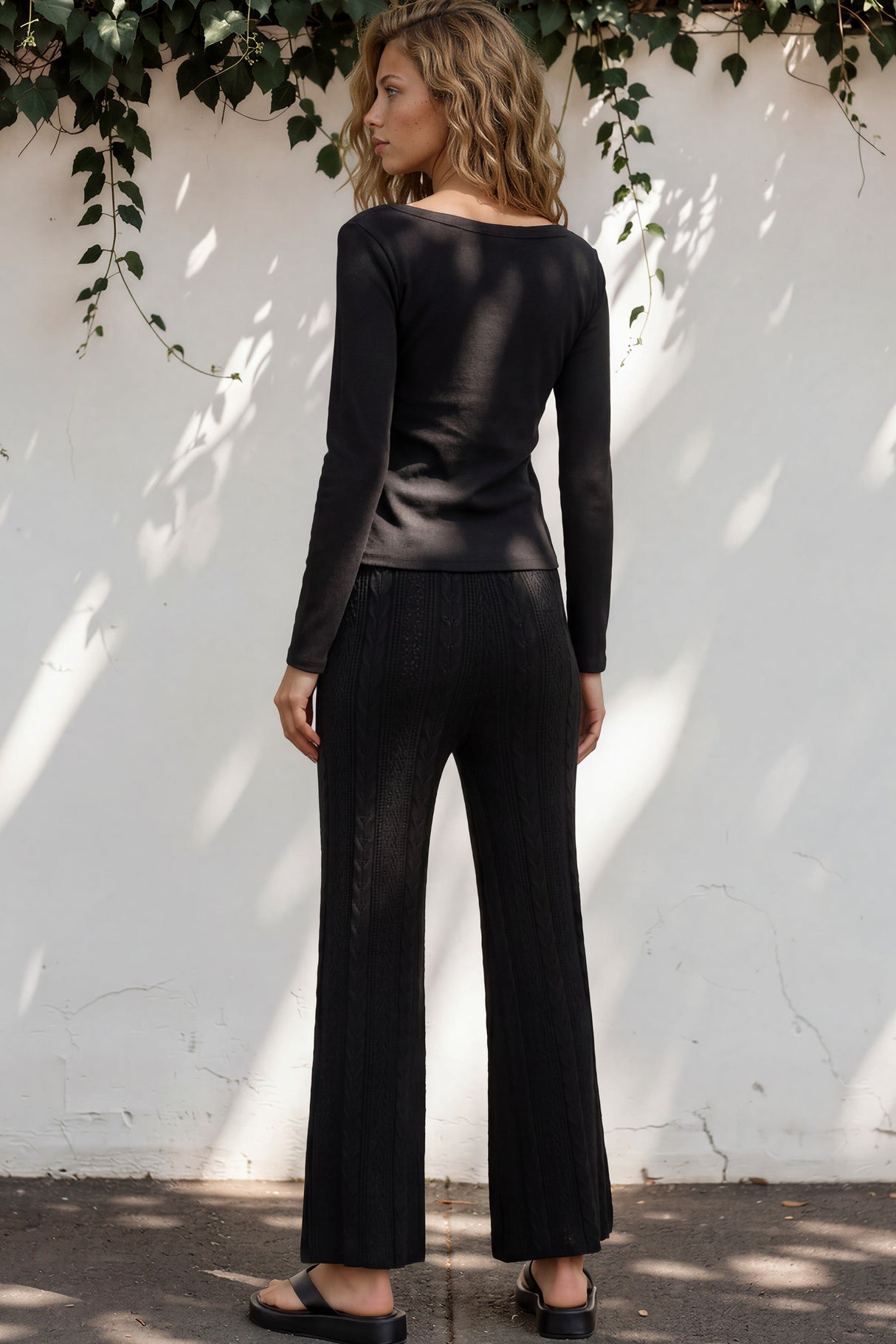 Model wearing Ravio Knit Pants in Black from Salty Crush