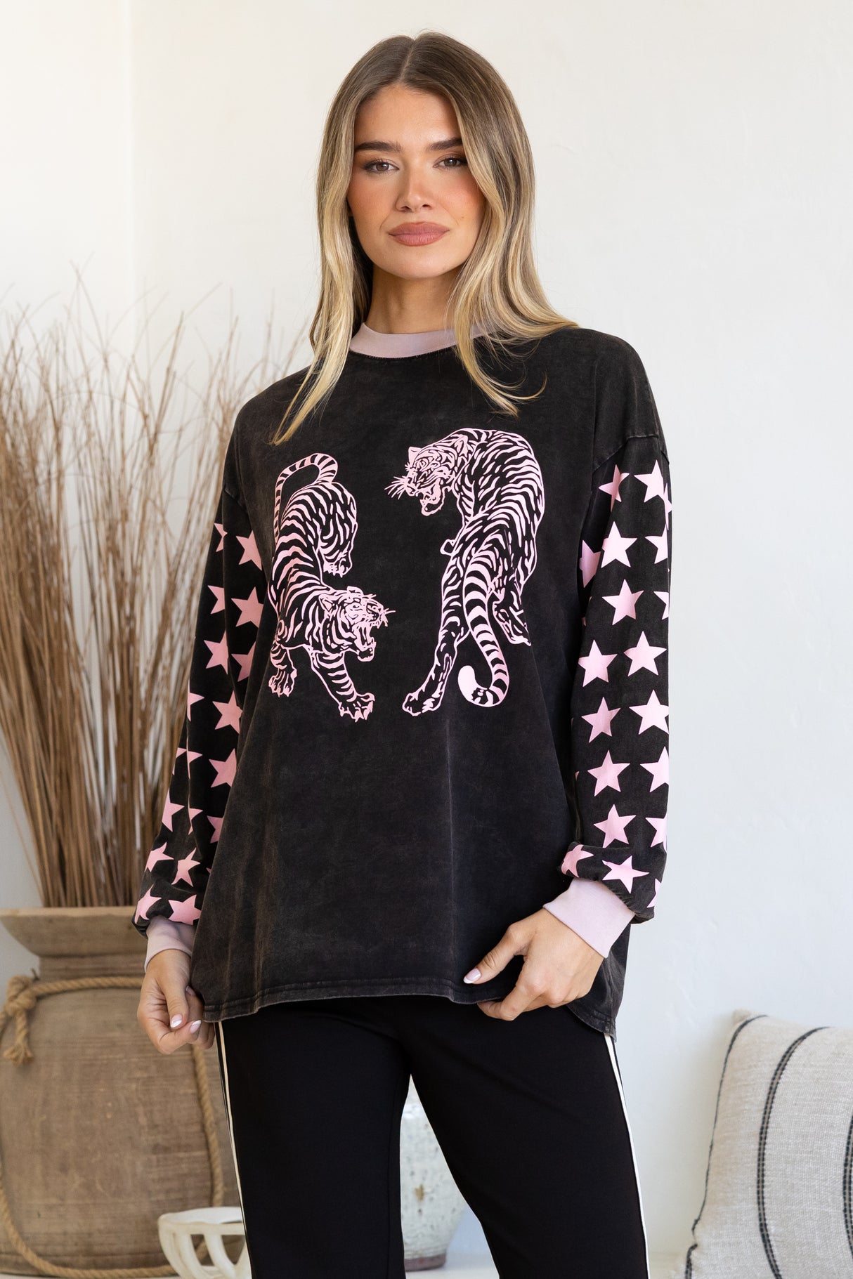 Model wearing Rival Tiger Long Sleeve Tee in Black Acid Wash from Salty Crush
