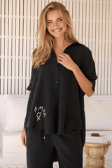 JAASE - River Shirt: Oversized Button Down Shirt with Scoop High-Low Hem in Love Is All Around Print- Black