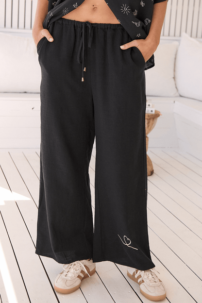 JAASE - Cici Pants: Mid Rise Relaxed Wide Leg Pant in Love Is All Round Print - Black
