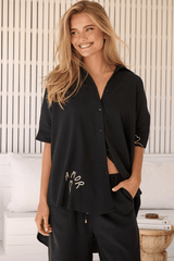 JAASE - River Shirt: Oversized Button Down Shirt with Scoop High-Low Hem in Love Is All Around Print- Black