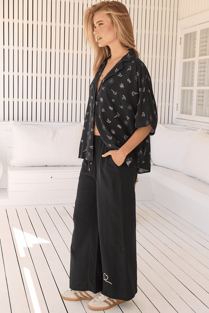 JAASE - Cici Pants: Mid Rise Relaxed Wide Leg Pant in Love Is All Round Print - Black