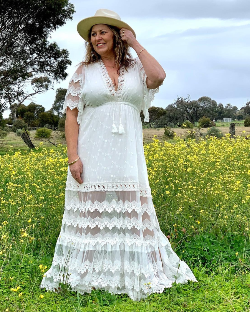 A woman models a white Salty Crush dress
