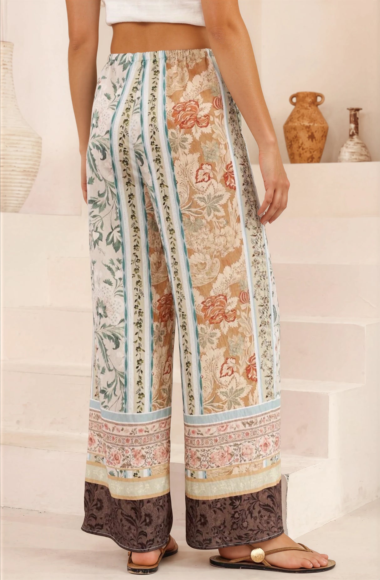 Person wearing patterned pants with a neutral background
