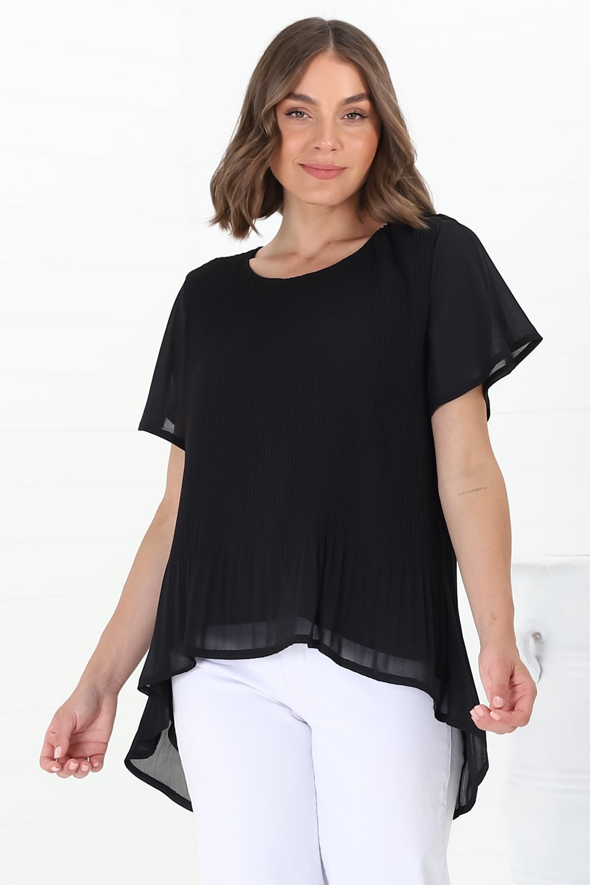 Alek Blouse - Plisse Cap Sleeve Top with High-Low Hemline in Black