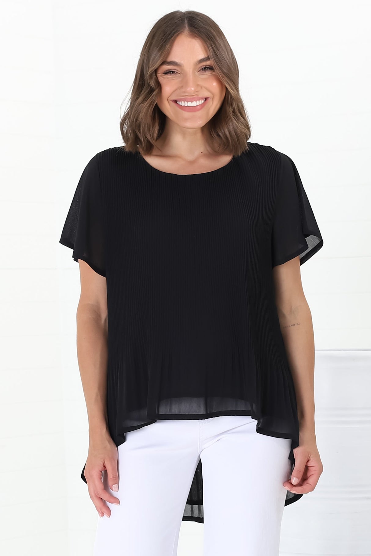 Alek Blouse - Plisse Cap Sleeve Top with High-Low Hemline in Black