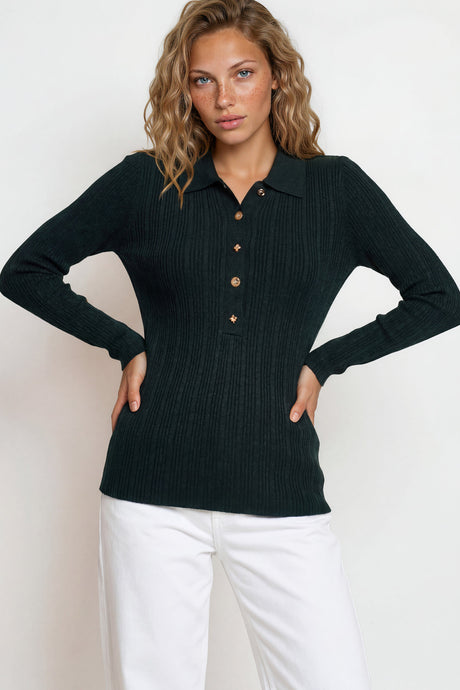 Woman wearing a black ribbed sweater with button details against a white background