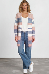 Woman wearing a striped cardigan, white top, blue jeans, and white sneakers on a plain background