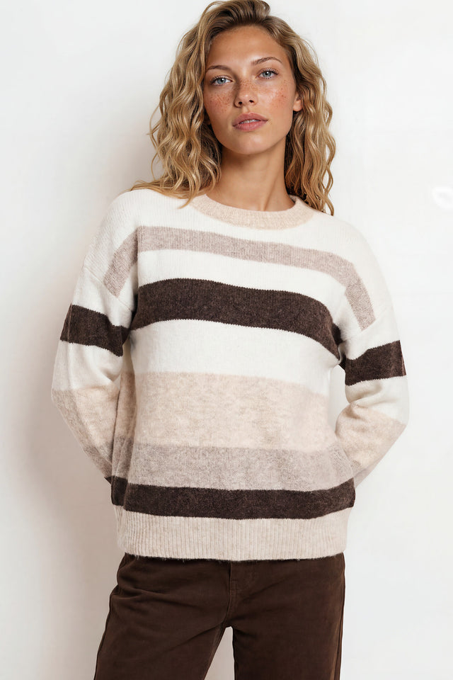 Woman wearing a striped sweater with a plain background