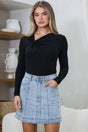 Model wearing Astin Denim Mini Skirt in Light Denim from Salty Crush