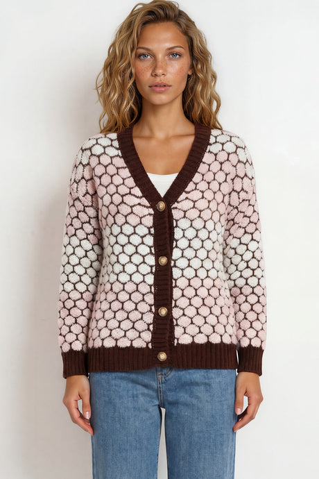 Woman wearing a patterned cardigan and jeans on a white background