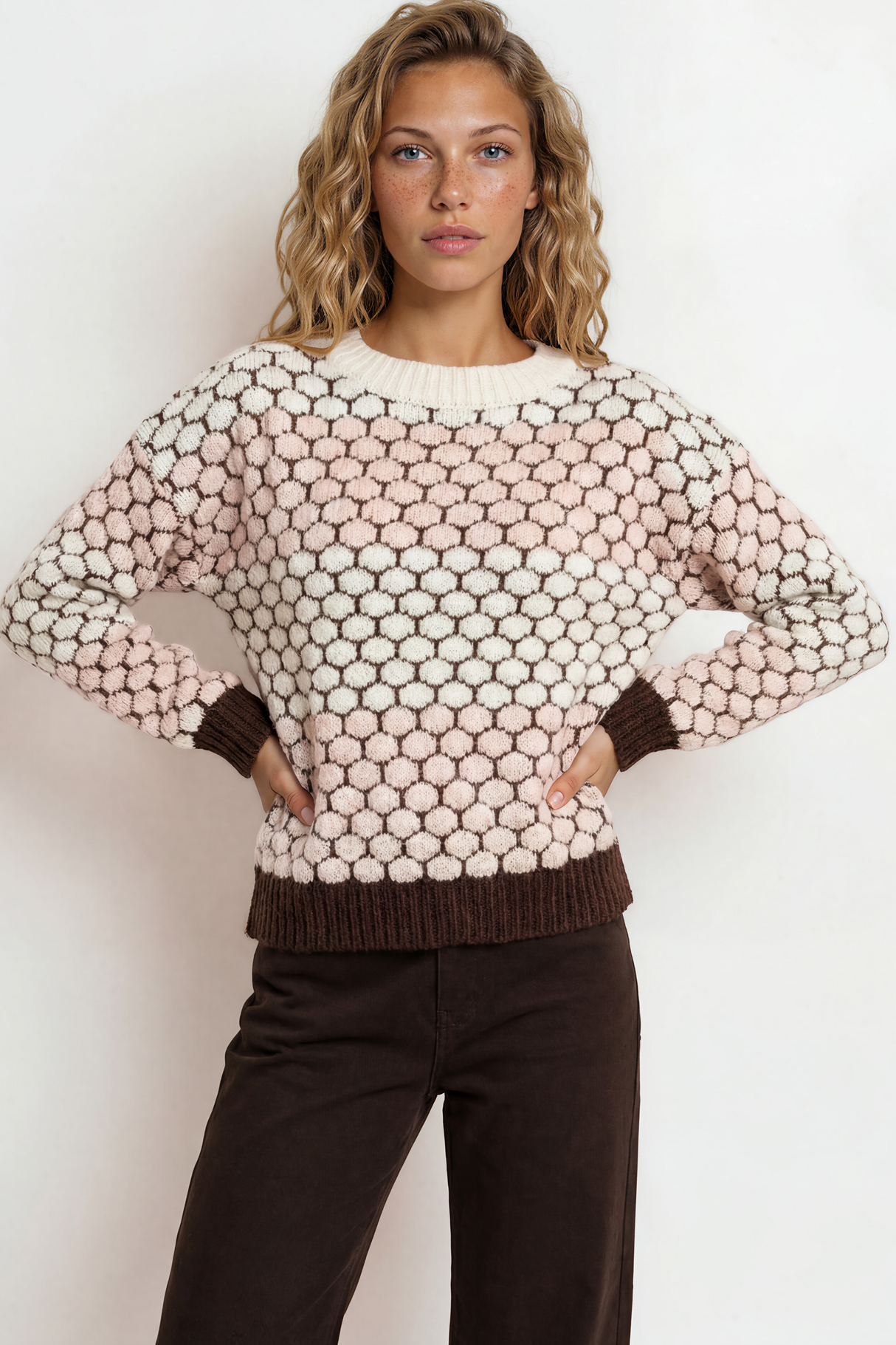 Woman wearing a patterned sweater against a white background