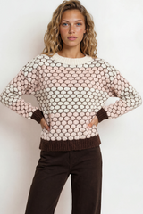 Woman wearing a patterned sweater against a white background