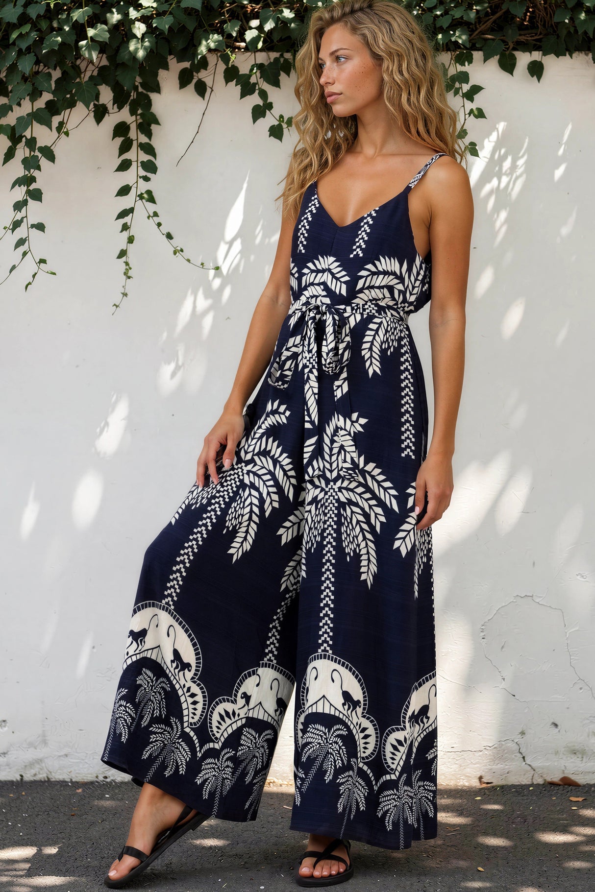 Model wearing Brittany Jumpsuit in Kora Print Navy from Salty Crush

