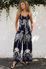 Model wearing Brittany Jumpsuit in Kora Print Navy from Salty Crush
