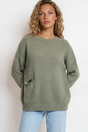 Model wearing Caesar Jumper in Green from Salty Crush