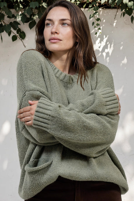 Model wearing Caesar Jumper in Green from Salty Crush