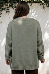 Model wearing Caesar Jumper in Green from Salty Crush