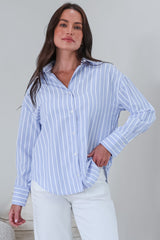 Model wearing a striped blue polo from Salty Crush