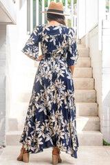 Model shows off the back side of the Frigg Maxi Dress - a floral boho dress and very popular style from Salty Crush