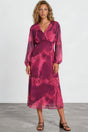 Woman wearing a pink tie-dye dress against a white background
