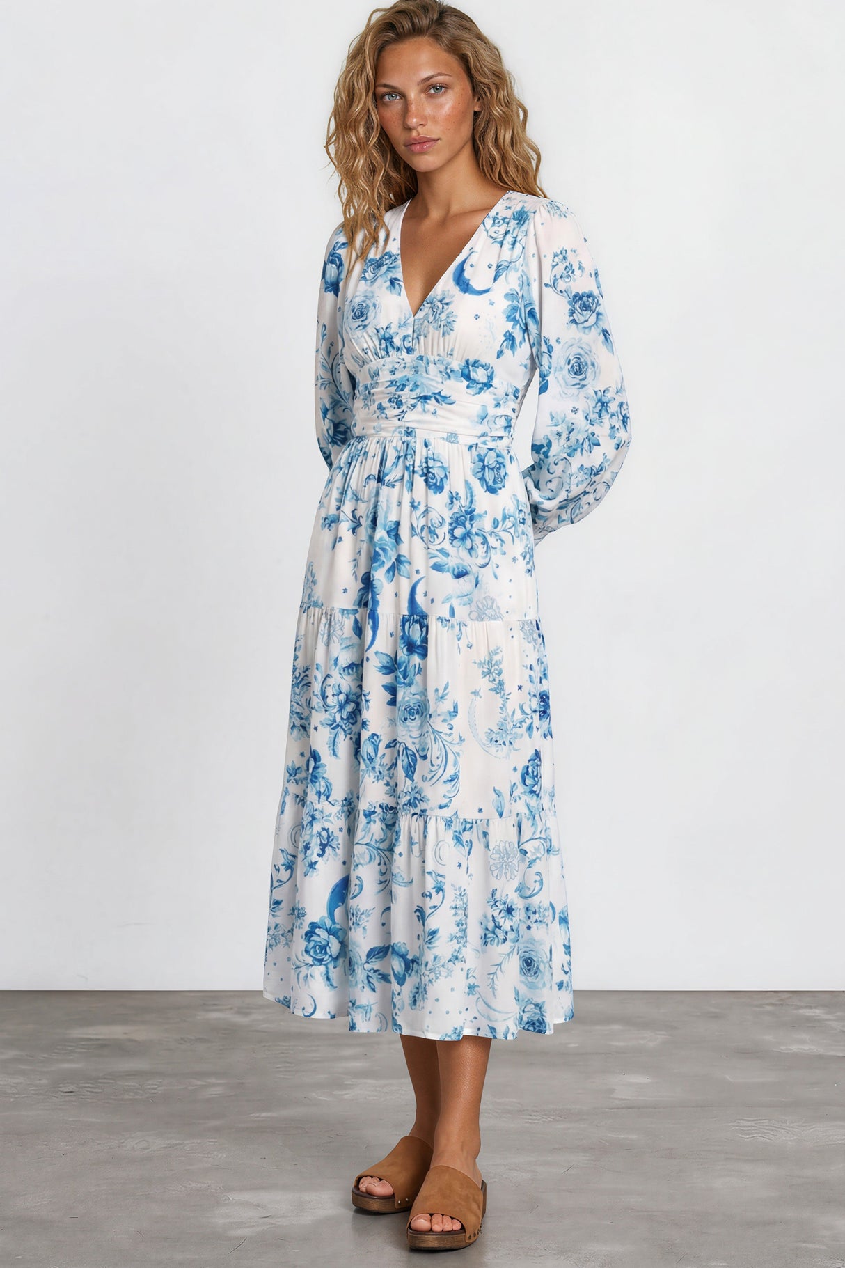 Woman wearing a blue floral dress on a white background