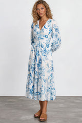Woman wearing a blue floral dress on a white background