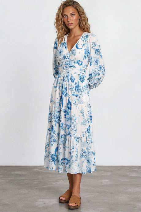 Woman wearing a blue floral dress on a white background