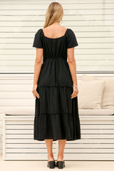 Model wearing Karina Midi Dress in Black from Salty Crush
