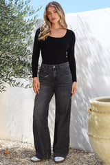 Model wearing Kash Jeans in Black Acid Wash from Salty Crush