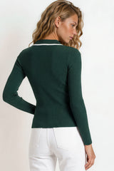 Woman wearing a green sweater with a white collar against a light background