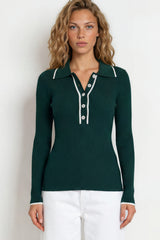 Woman wearing a green long-sleeve shirt and white pants on a white background