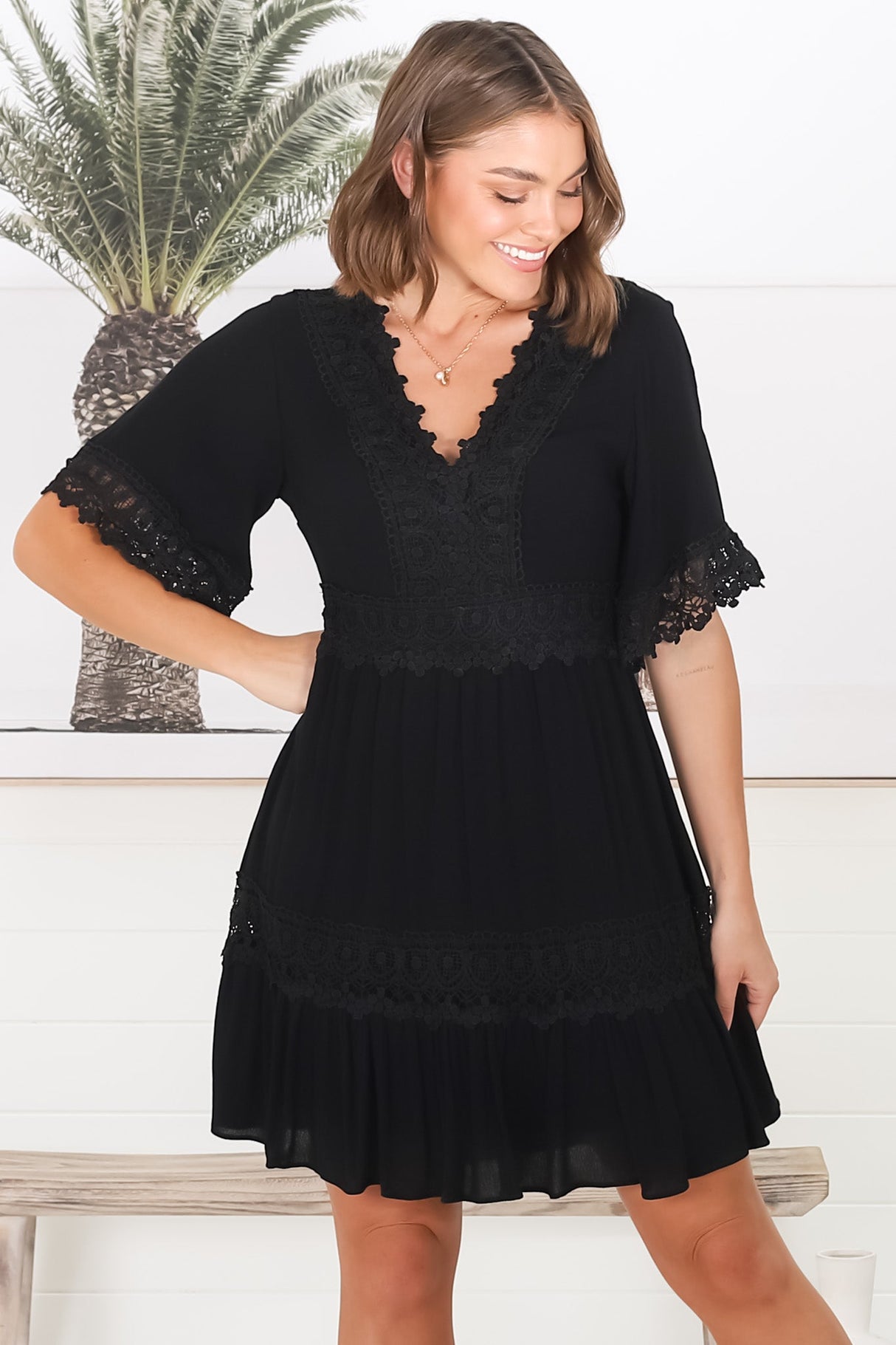 Leelie Mini Dress - Lace Embelished Tiered Dress with Bell Sleeves in Black