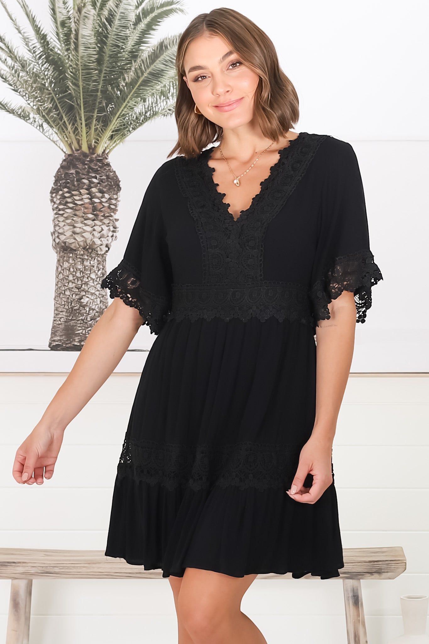 Leelie Mini Dress - Lace Embelished Tiered Dress with Bell Sleeves in Black