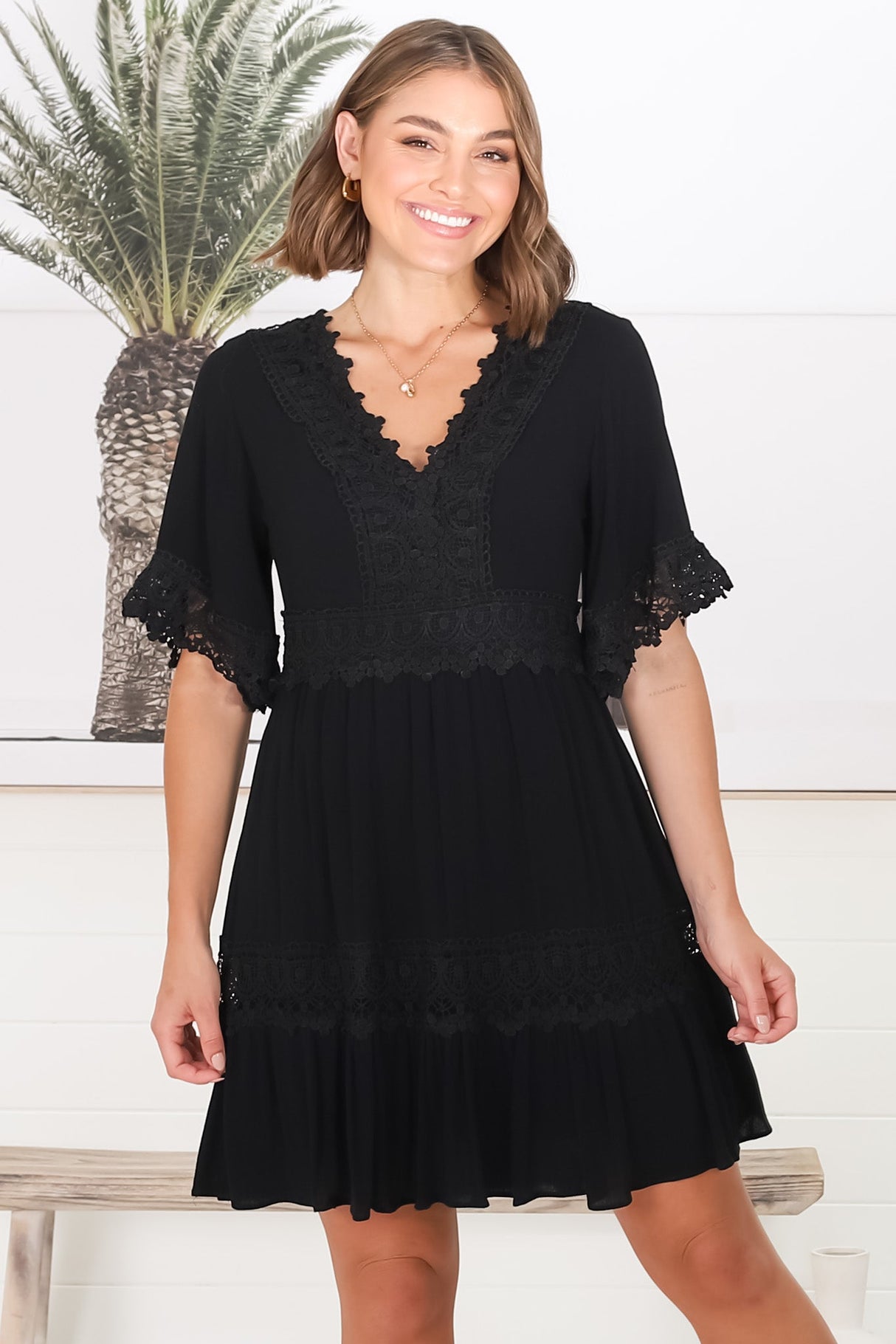 Leelie Mini Dress - Lace Embellished Tiered Dress with Bell Sleeves in Black