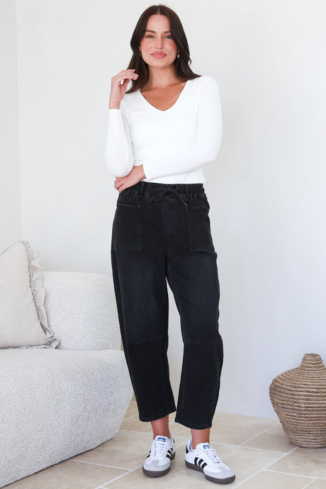Model wearing Lowen Barrel Jeans in Black from Salty Crush