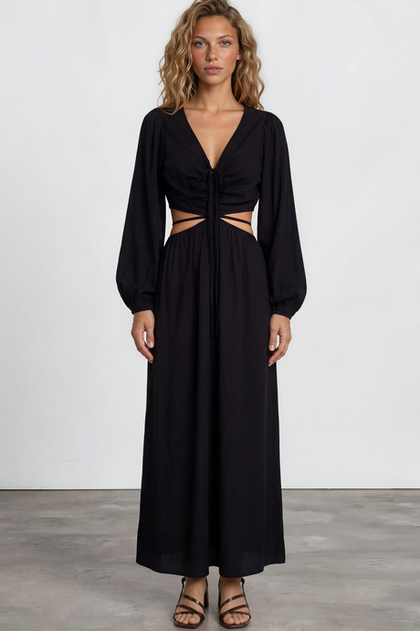 Woman wearing a black dress with cut-out design on a white background