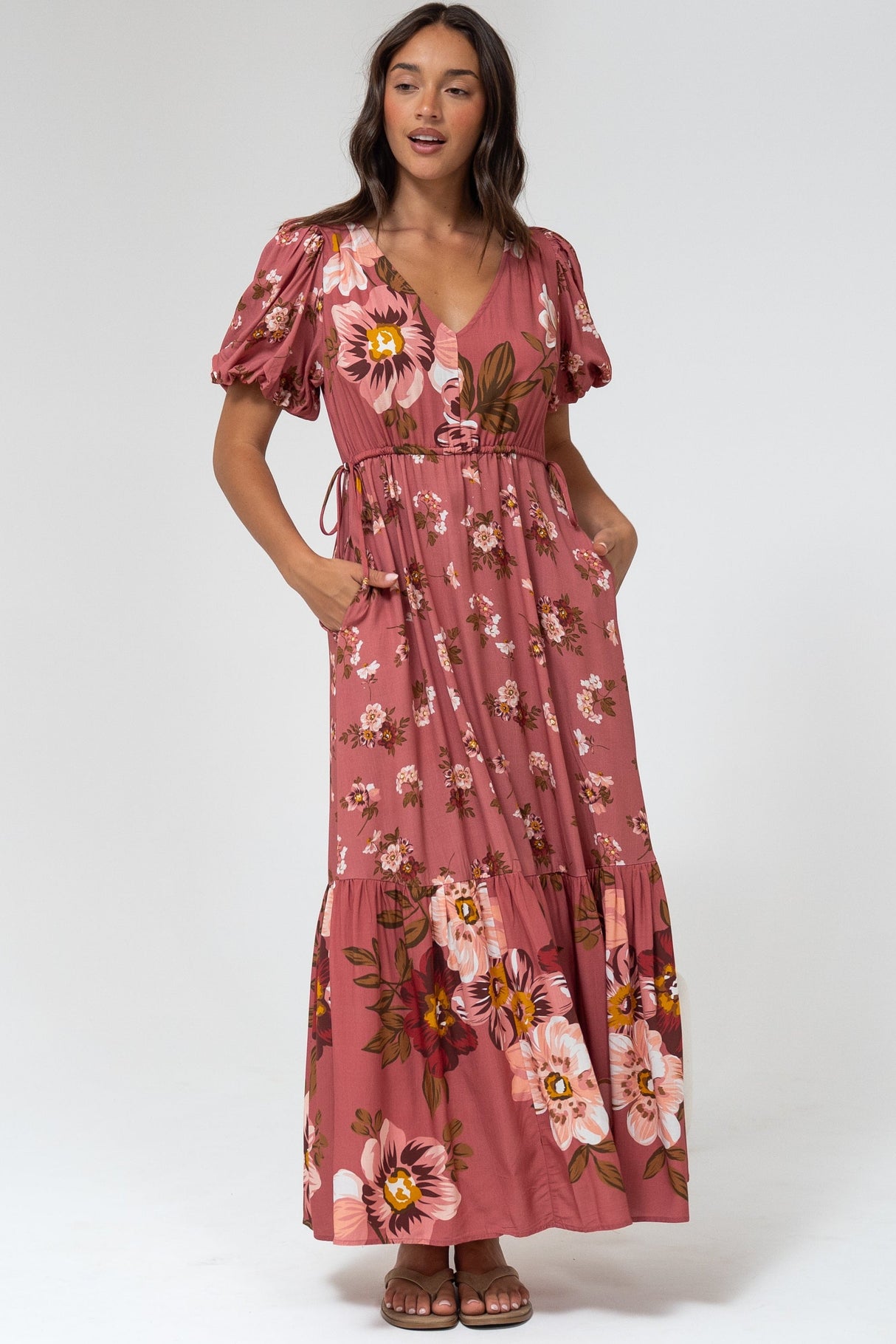 Woman wearing a floral dress in a studio setting