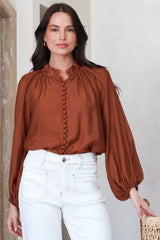 Model wearing Portia Blouse in Rust from Salty Crush