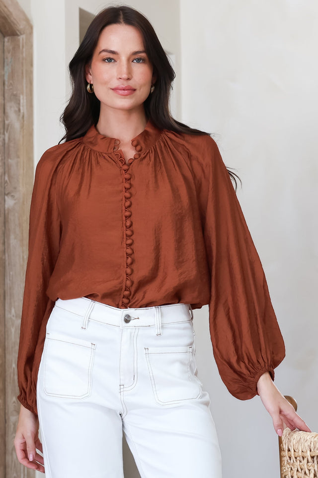 Model wearing Portia Blouse in Rust from Salty Crush