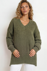 Woman wearing a green sweater against a white background