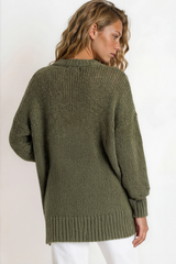 Woman wearing a green sweater against a white background