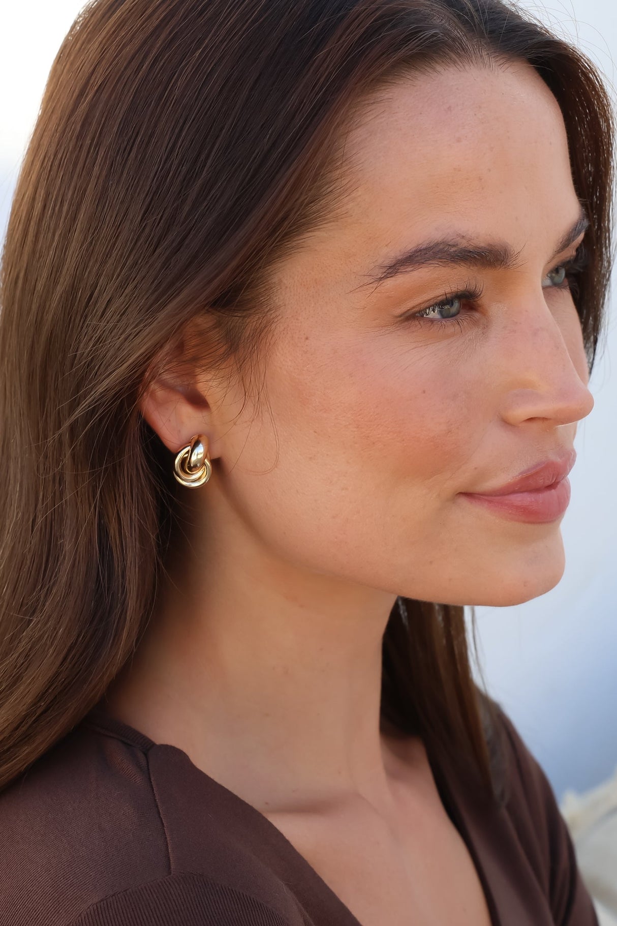 Model wearing Zana Earrings in Gold from Salty Crush