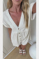 Perry Playsuit - V Neck Short Sleeve Button Down Playsuit with Pockets in Beige